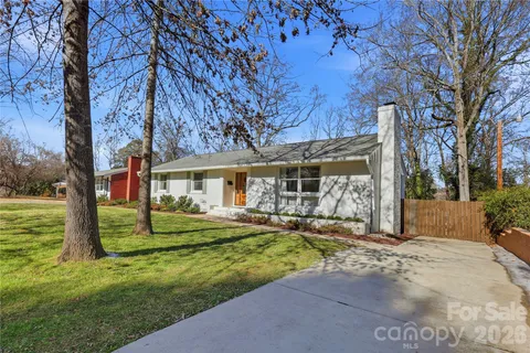a view of a house with a yard and tree s