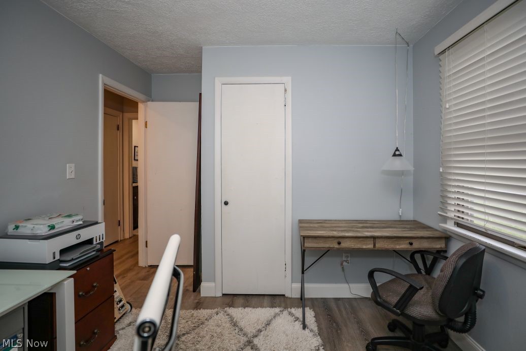 10676 Holcomb Road Newton Falls, OH 44444 - Photo 26 of 38 Bedroom set up as a office with LVT floors and a textured ceiling