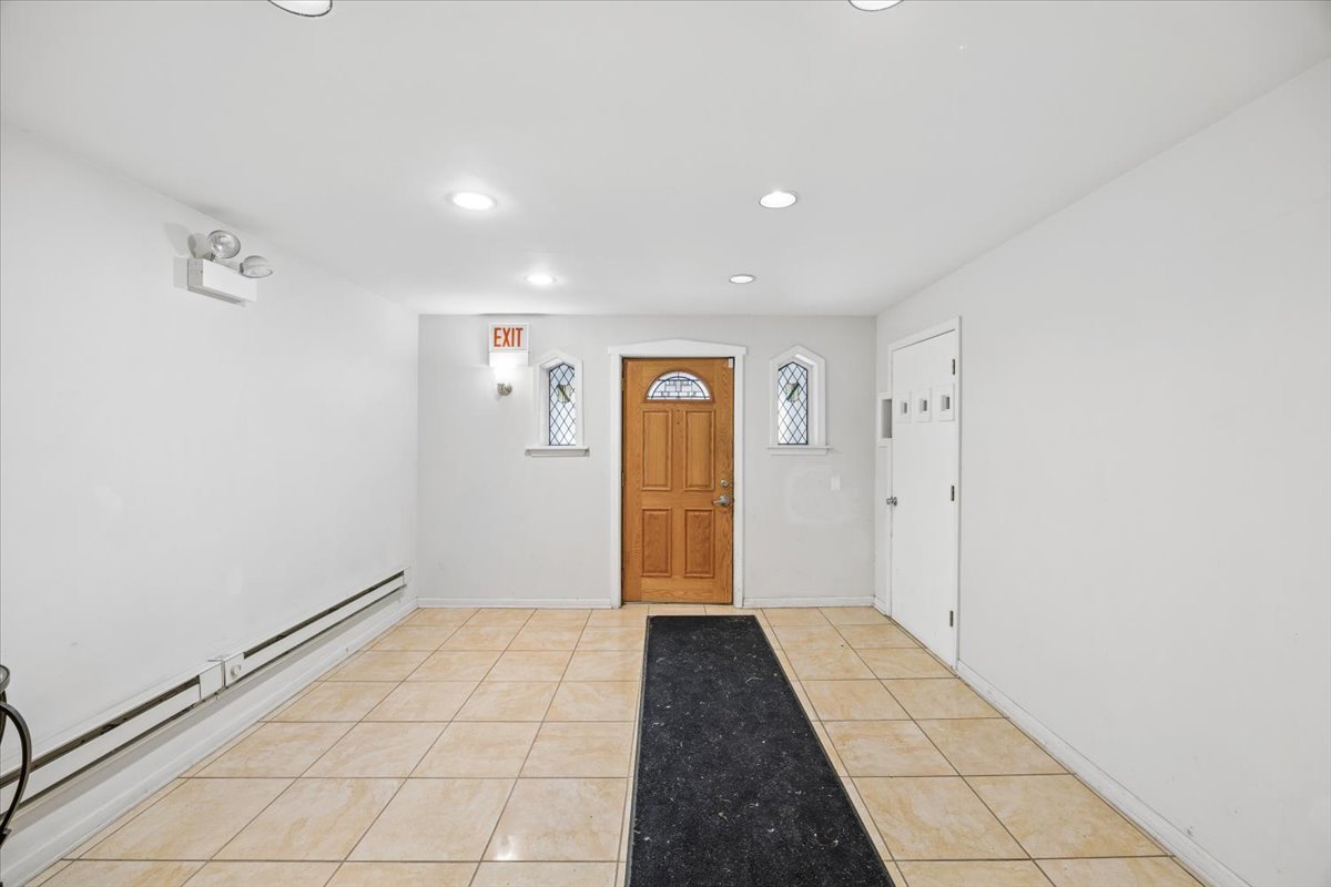 2363 East 70th Street, Unit 1 Chicago, IL 60649 - Photo 2 of 26 a view of hallway with a window and a refrigerator