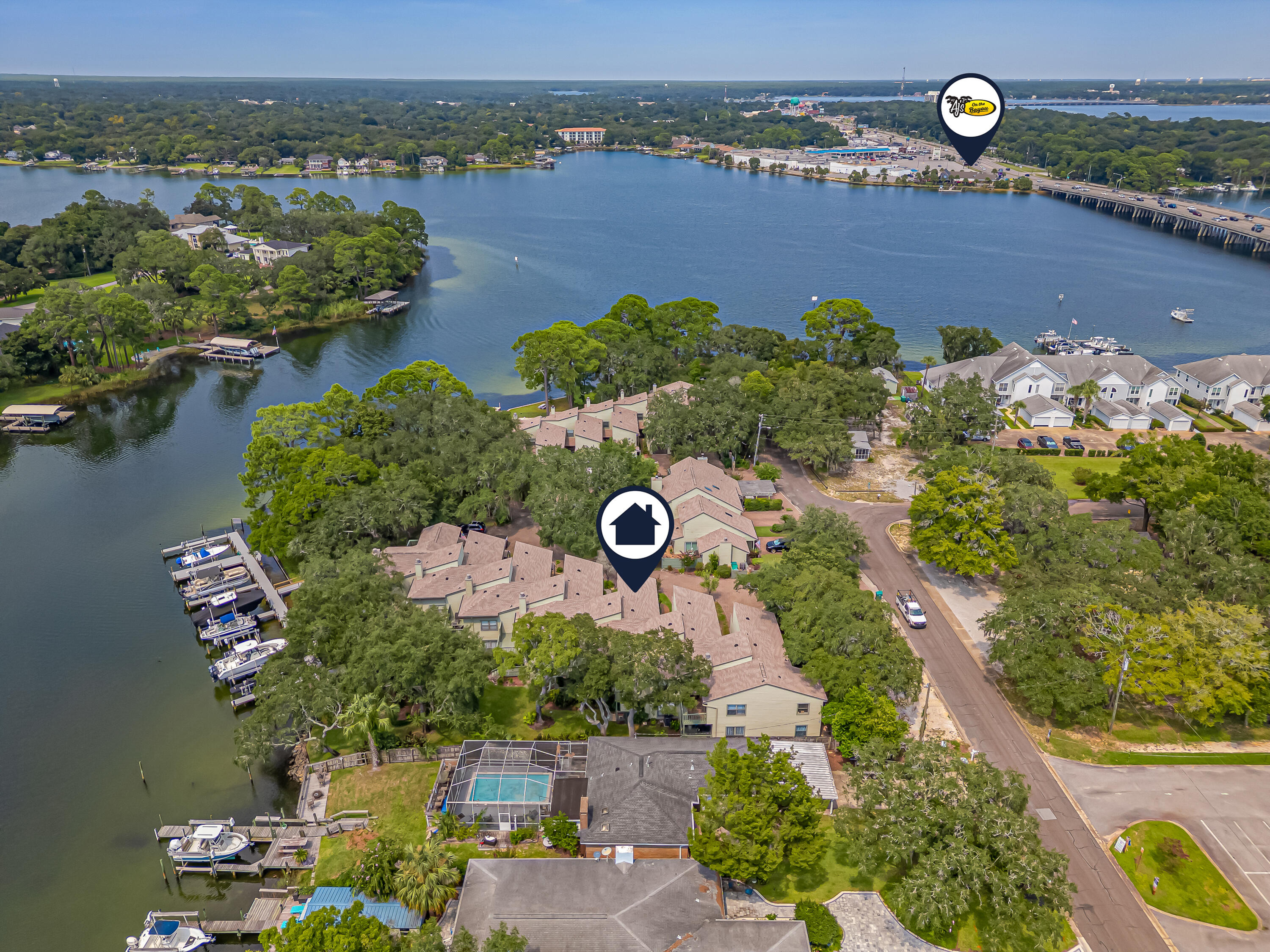 an aerial view of a house with a yard and lake view