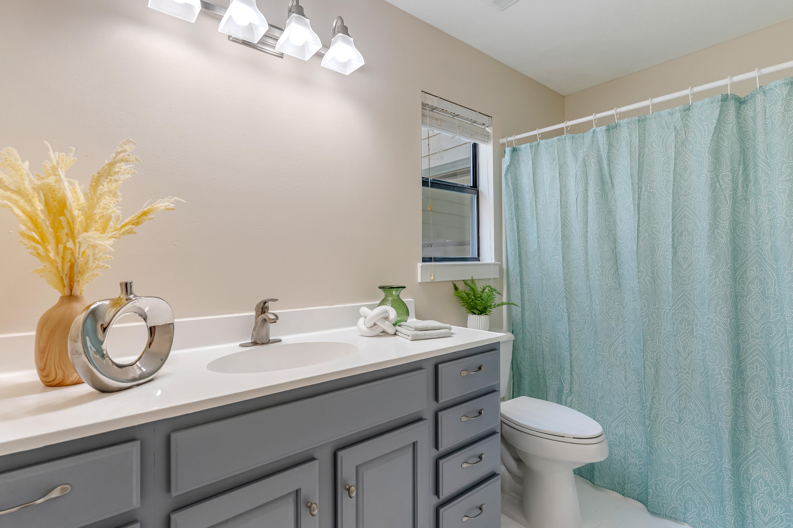 274 Kidd Street Fort Walton Beach, FL 32548 - Photo 42 of 74 a bathroom with a granite countertop sink a toilet and a mirror