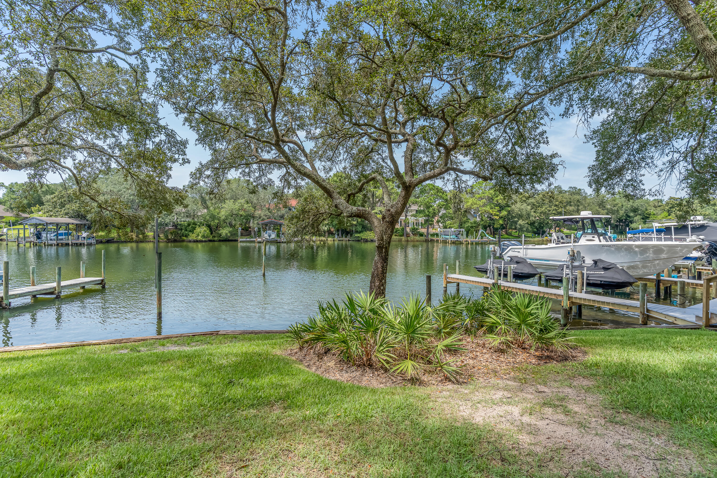 274 Kidd Street Fort Walton Beach, FL 32548 - Photo 55 of 74 a backyard of a house with lots of green space and lake view