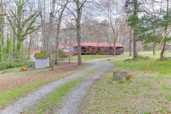 a view of a house with a yard and sitting area