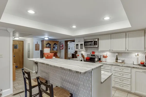 a view of a livingroom with workspace and a window