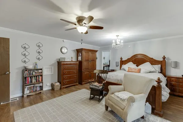 a living room with furniture and a book shelf
