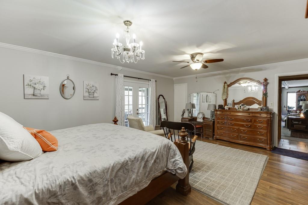 722 Charlie Morris Road Colbert, GA 30628 - Photo 28 of 78 a bedroom with a bed and ceiling fan