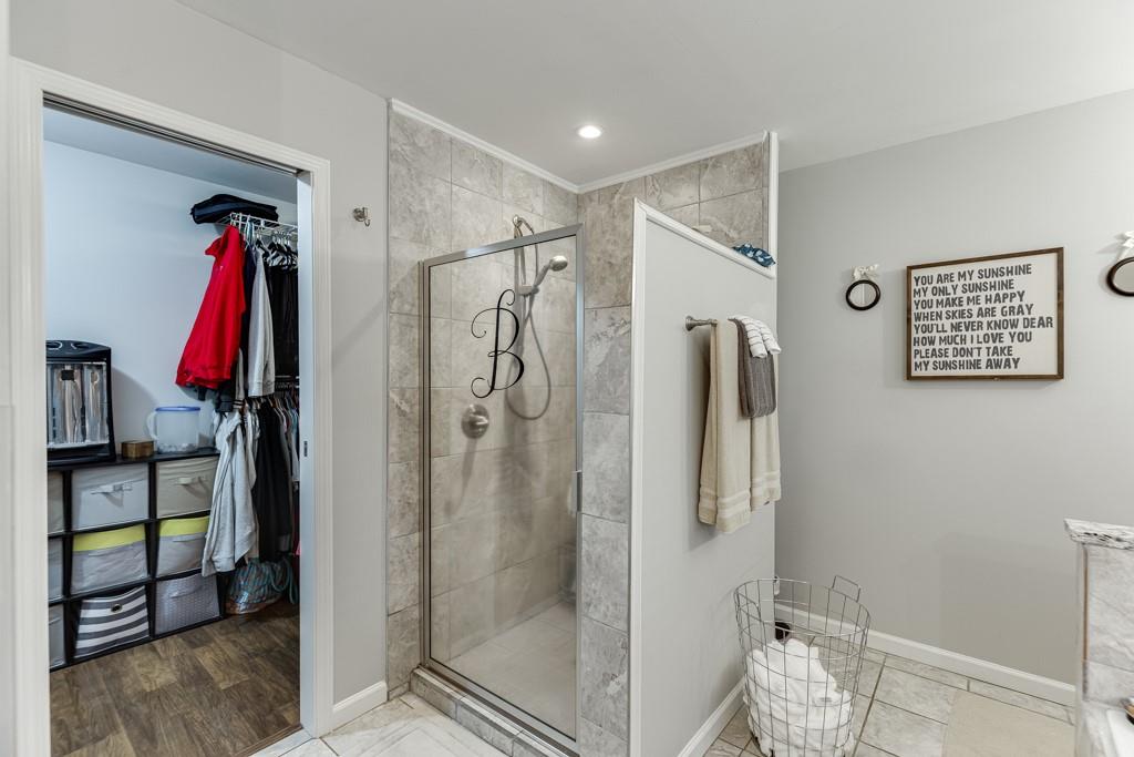 722 Charlie Morris Road Colbert, GA 30628 - Photo 32 of 78 a view of walk in closet with clothes and shoes