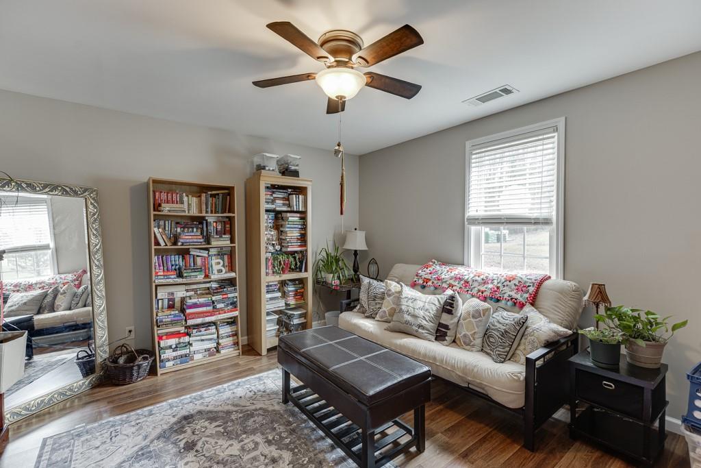 722 Charlie Morris Road Colbert, GA 30628 - Photo 36 of 78 a living room with furniture and a book shelf