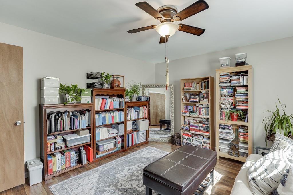 722 Charlie Morris Road Colbert, GA 30628 - Photo 37 of 78 a living room with a book shelf and a book shelf