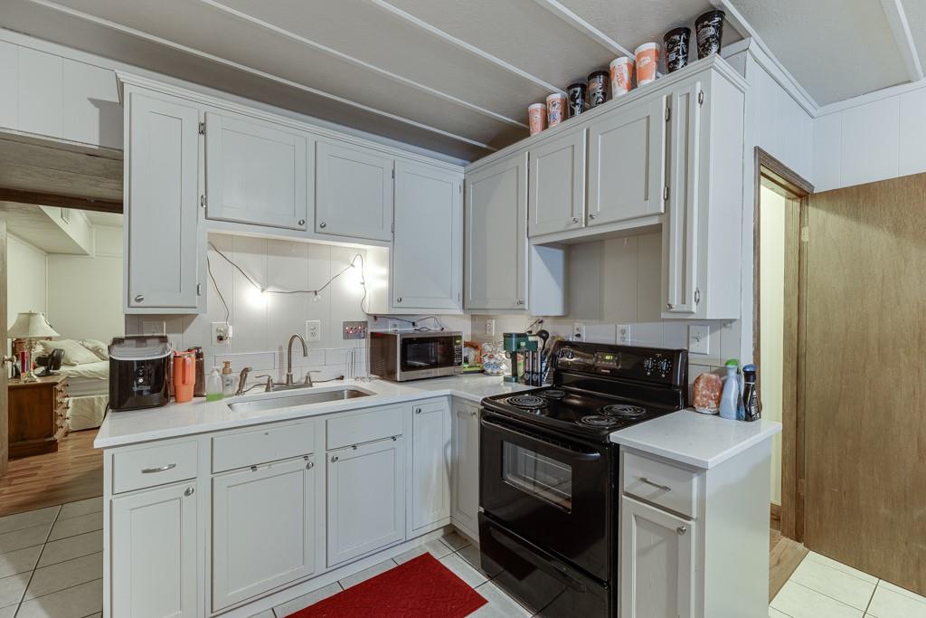 722 Charlie Morris Road Colbert, GA 30628 - Photo 46 of 78 a kitchen with cabinets appliances a sink and a counter top space