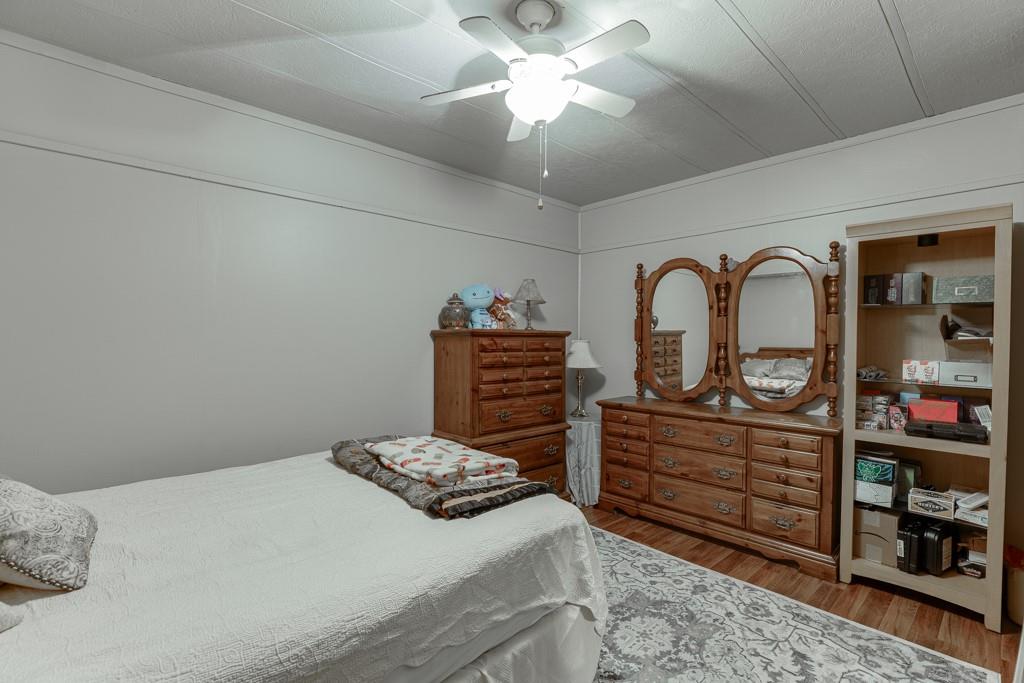722 Charlie Morris Road Colbert, GA 30628 - Photo 51 of 78 a bedroom with a bed and a dresser