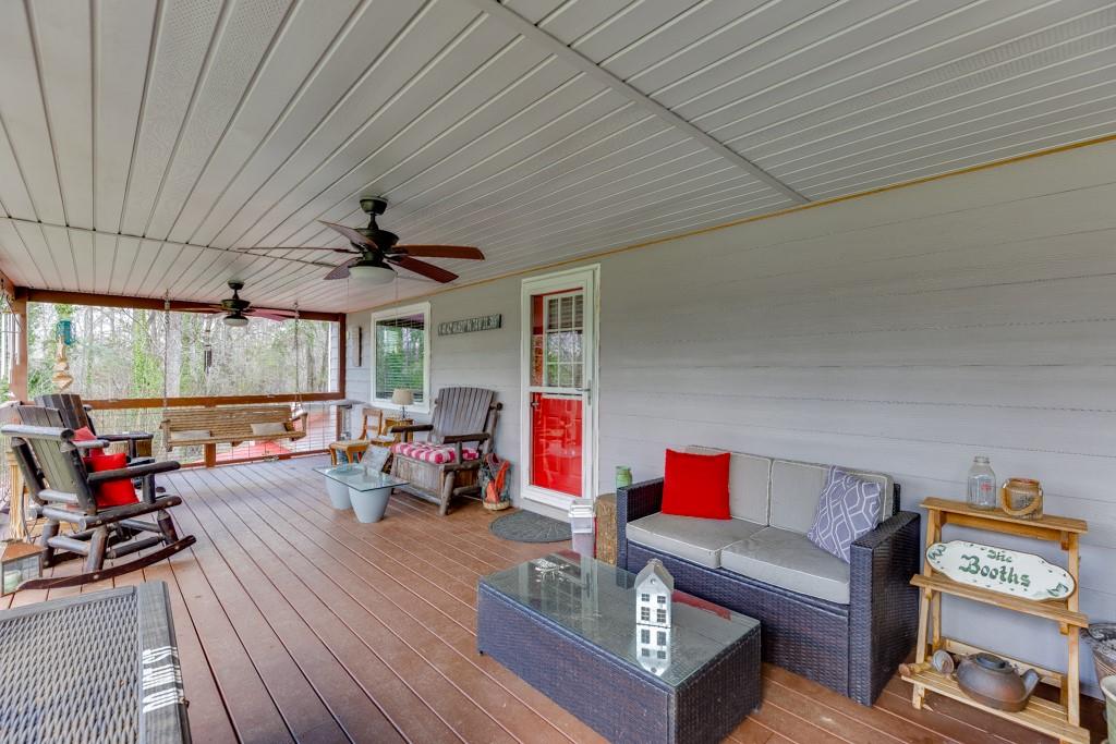 722 Charlie Morris Road Colbert, GA 30628 - Photo 6 of 78 a living room with furniture a flat screen tv and a large window