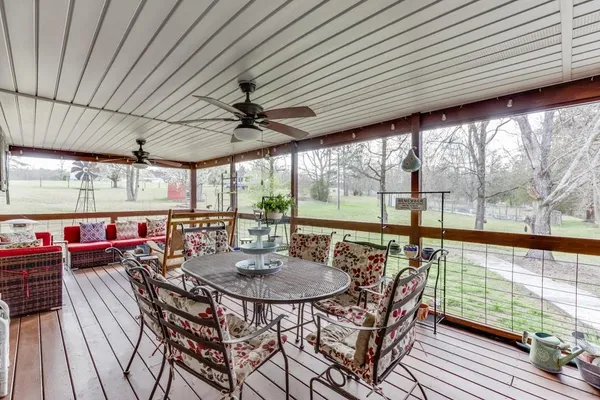 a roof deck with wooden floor and outdoor seating
