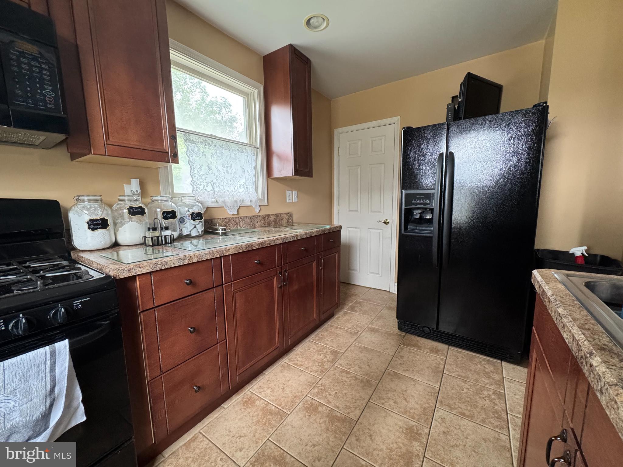 320 Harding Avenue Baltimore, MD 21220 - Photo 9 of 23 a kitchen with stainless steel appliances granite countertop a refrigerator and a stove top oven