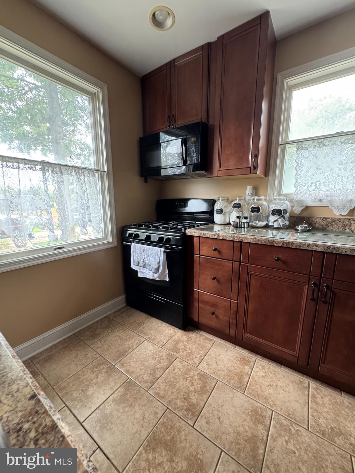320 Harding Avenue Baltimore, MD 21220 - Photo 10 of 23 a kitchen with stainless steel appliances granite countertop a stove a sink and a microwave