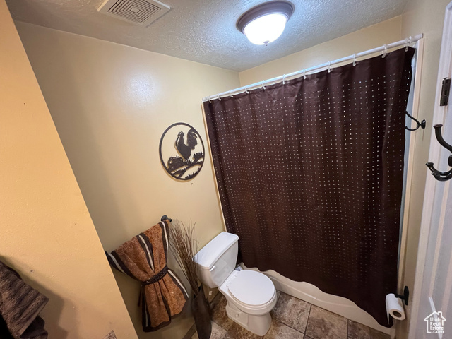 2548 South 700 West Perry, UT 84302 - Photo 8 of 18 Full bathroom featuring a textured ceiling and shower / bathtub combination with curtain