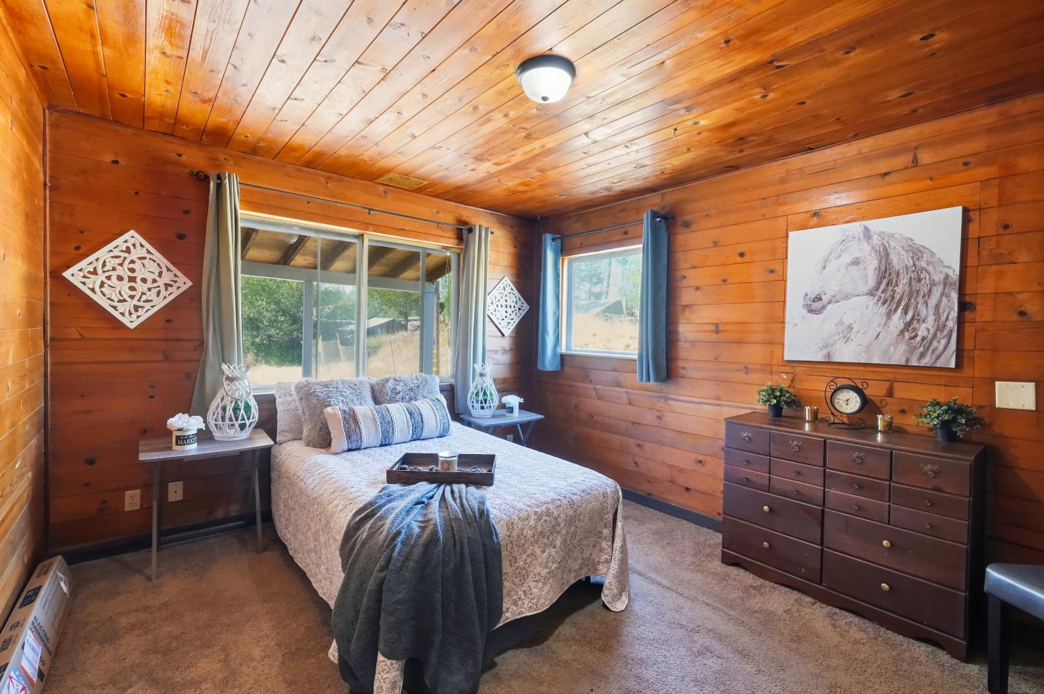 13351 Newtown Road Nevada City, CA 95959 - Photo 7 of 50 a spacious bedroom with a bed and wooden floor
