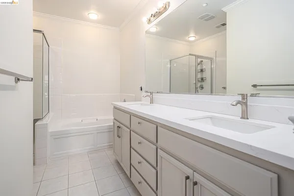 a bathroom with a tub sink and mirror