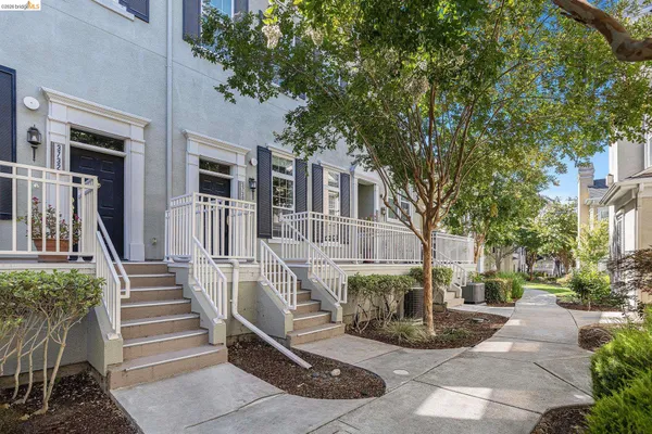 a view of a building with a bench in the patio