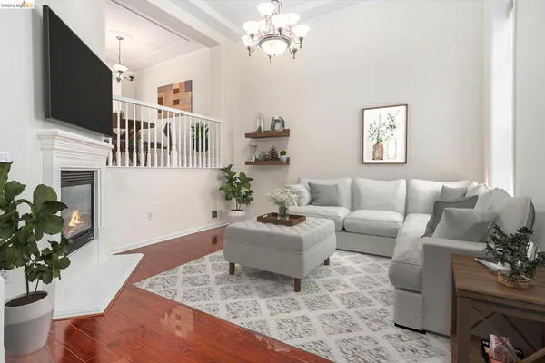 a living room with furniture a chandelier and a flat screen tv