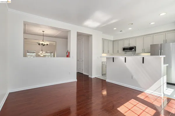 a view of a kitchen with wooden floor and a window