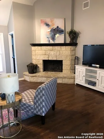 a living room with furniture fireplace and flat screen tv