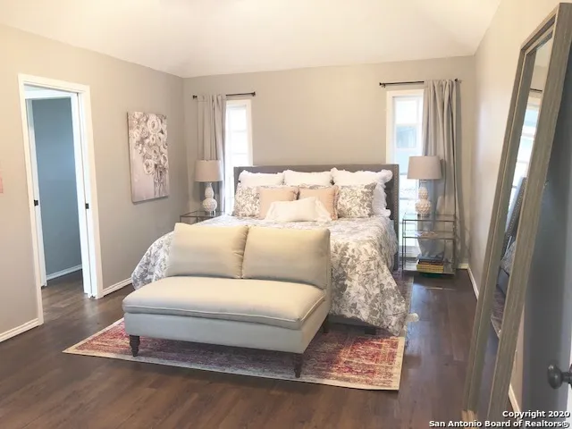 a living room with a bed and a table