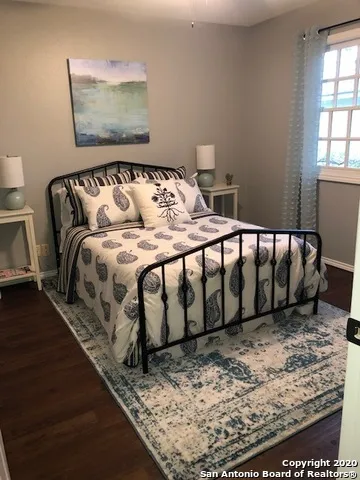 a bed sitting in a bedroom next to a window