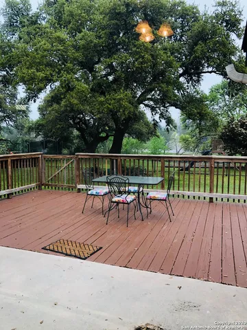 a view of a wooden deck with chairs