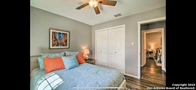 a bedroom with a large bed and a chandelier