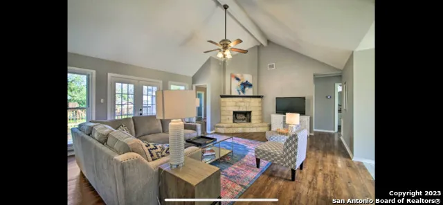 a living room with furniture fireplace and flat screen tv