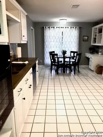 a kitchen with a sink and a stove top oven