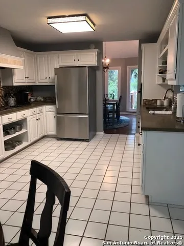 a kitchen with stainless steel appliances a refrigerator sink stove microwave and cabinets