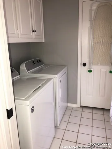 a view of a storage and utility room with washer and dryer