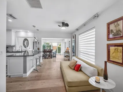 a living room with furniture kitchen and a window
