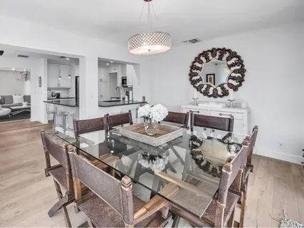 a view of a dining room with furniture and wooden floor