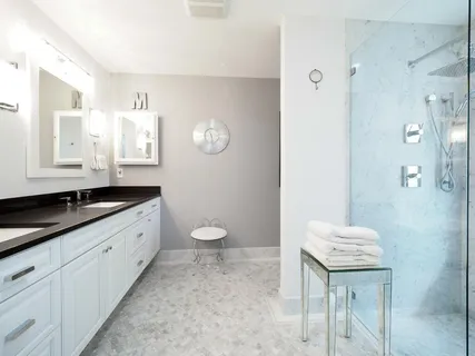 a bathroom with a granite countertop sink a toilet and mirror