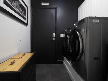 a view of a living room with floor to ceiling window and potted plants