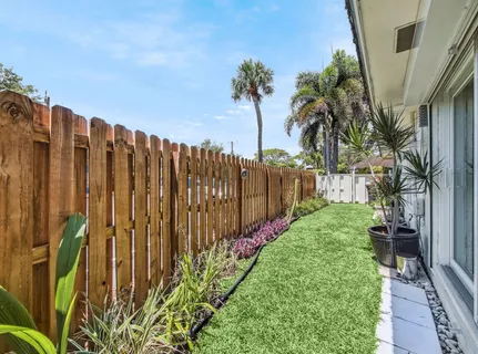 a view of a patio with table and chairs and potted plants