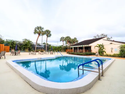 a view of tennis court and houses in the background