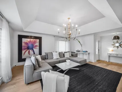 a living room with furniture and a chandelier