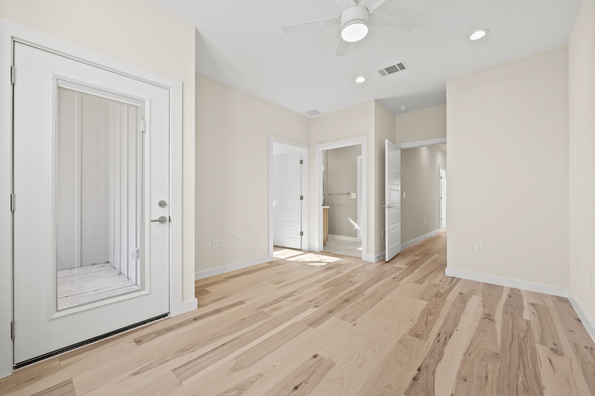 4801 Sara Drive, Unit A Austin, TX 78721 - Photo 26 of 40 a view of an empty room with wooden floor and door