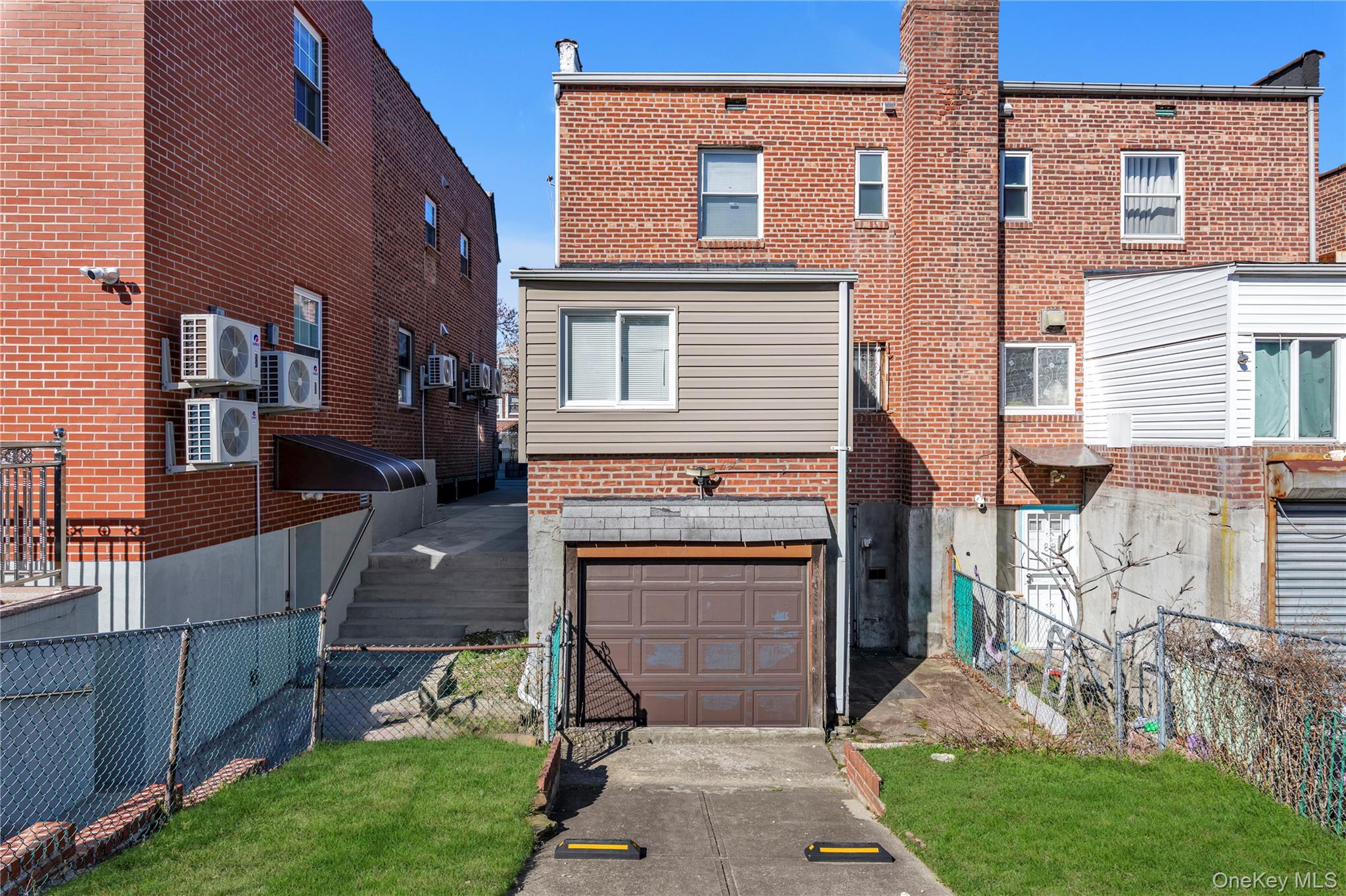 82-31 165th Street Queens, NY 11432 - Photo 15 of 16 a front view of a house with a garden