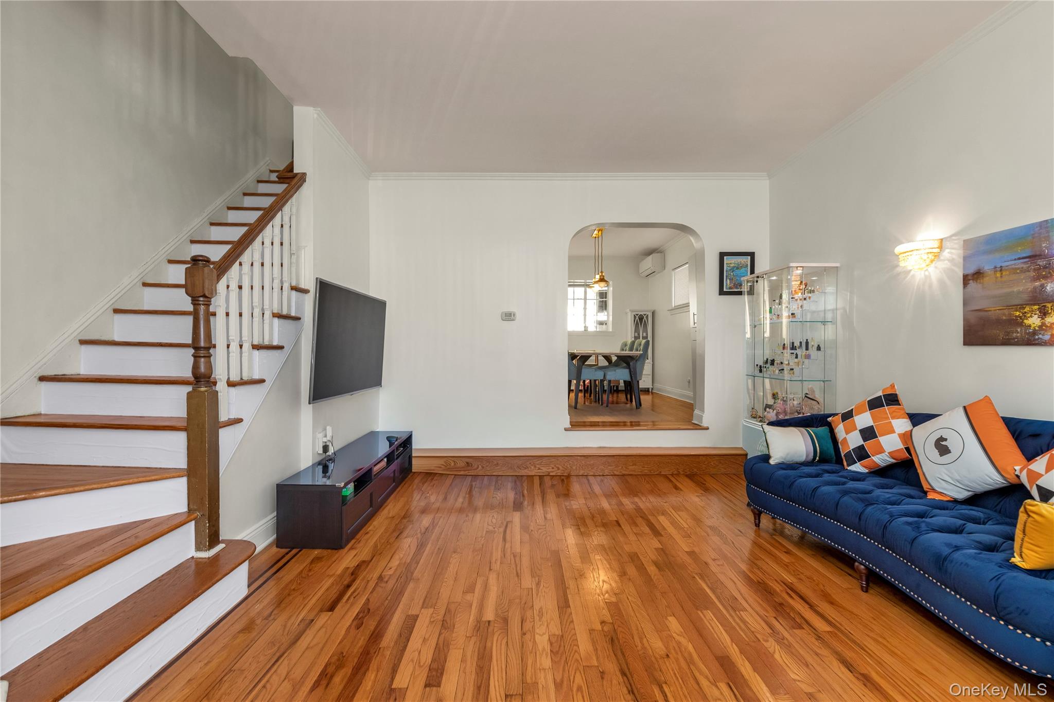 82-31 165th Street Queens, NY 11432 - Photo 2 of 16 a living room with furniture and a flat screen tv