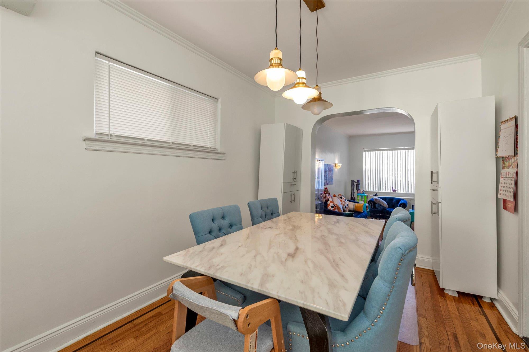 82-31 165th Street Queens, NY 11432 - Photo 4 of 16 a view of a dining room with furniture and wooden floor