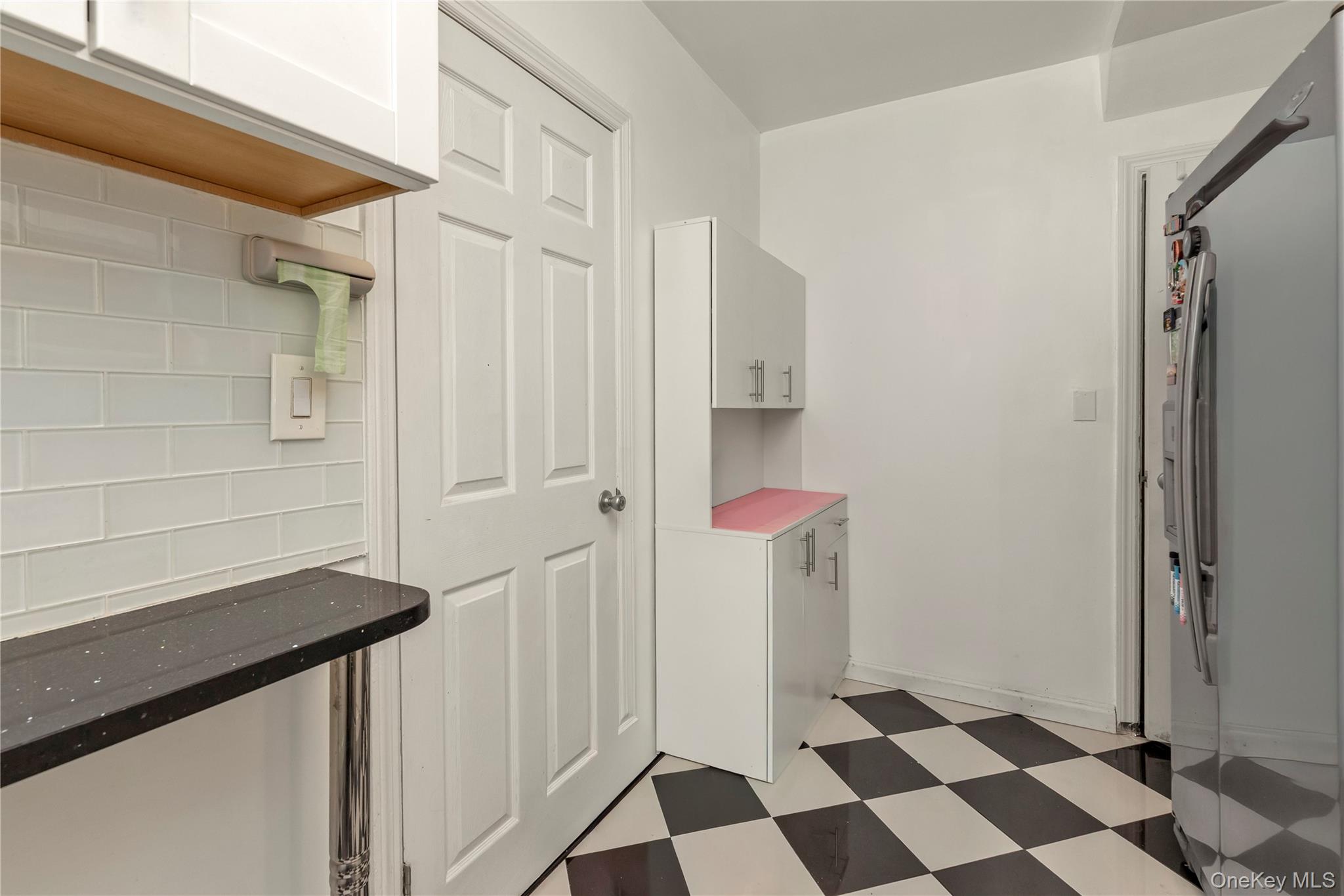 82-31 165th Street Queens, NY 11432 - Photo 6 of 16 a view of a bathroom with a sink and a mirror