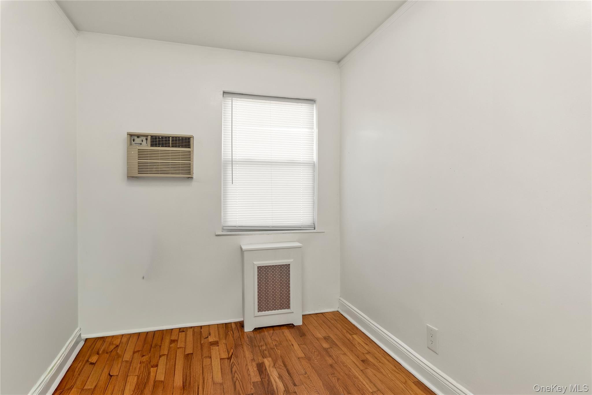 82-31 165th Street Queens, NY 11432 - Photo 10 of 16 a view of a room with wooden floor and a window