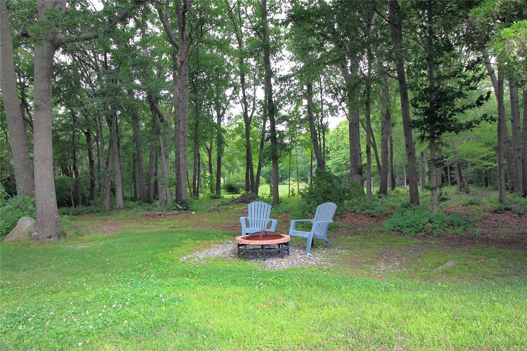 183 Fish Road Tiverton, RI 02878 - Photo 35 of 38 Relax around your fire pit. Beautiful wooded areas.