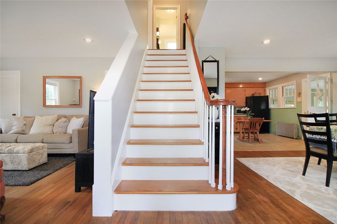 183 Fish Road Tiverton, RI 02878 - Photo 5 of 38 Central staircase to two bedrooms and full bath upstairs. Open dining kitchen plan and living area.