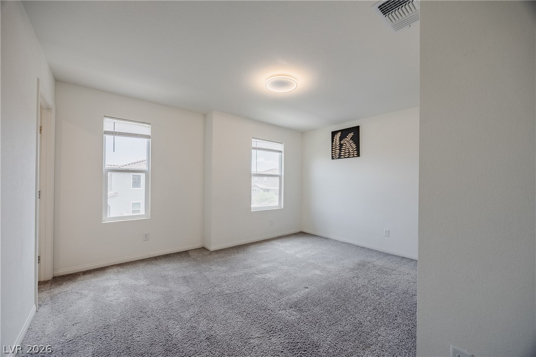 5927 Coja Street Las Vegas, NV 89113 - Photo 24 of 32 Spare room with plenty of natural light, carpet floors, and baseboards
